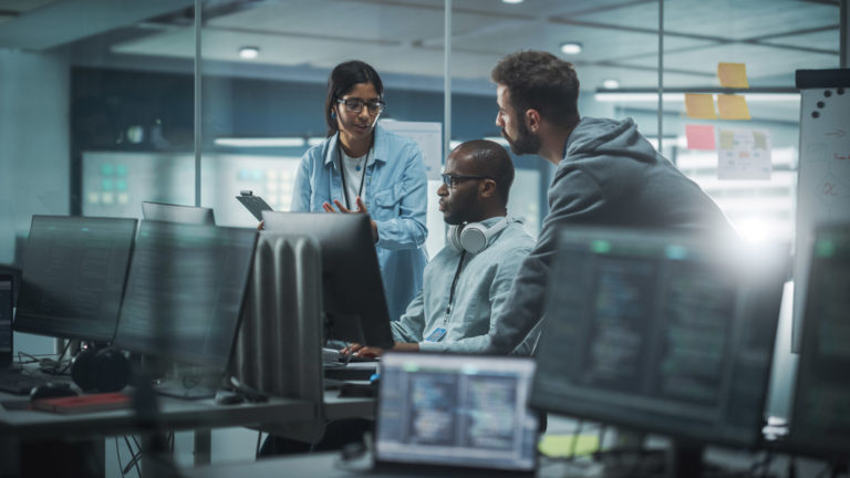 Diverse Group of Professionals Meeting in Modern Office: IT Programmers Use Computer, Talk Strategy, Discuss Planning.